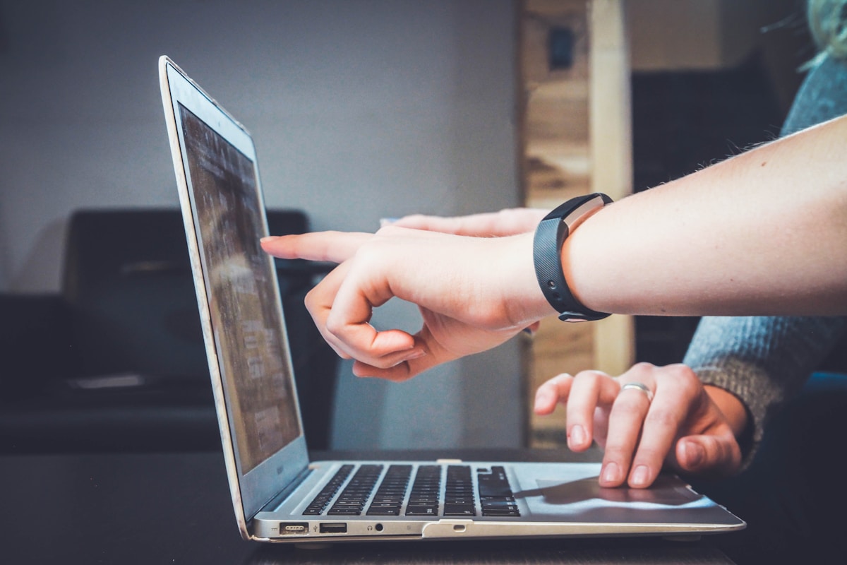 A real photograph of someone using a laptop.